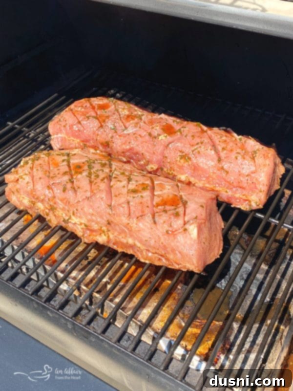 pork loin on grill cooking, smoke visible