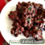 Peanut Clusters 2 Overhead view of homemade chocolate peanut clusters on a white plate