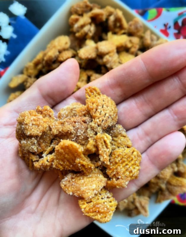 Caramel Churro Chex Mix in a bowl on a striped tablecloth