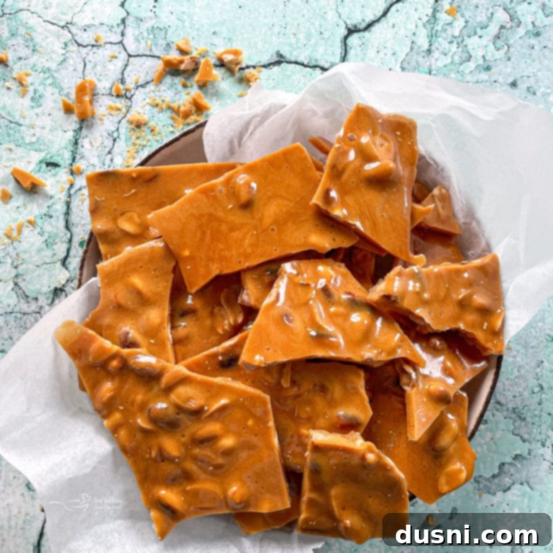 Close-up of freshly made peanut brittle ready to be served, highlighting its irresistible golden-brown color and embedded peanuts