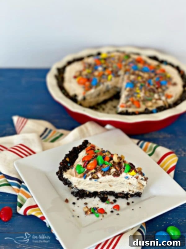 M&M Peanut Butter Bliss Pie 5 Multiple slices of Peanut M&M Peanut Butter Pie arranged on a cutting board.