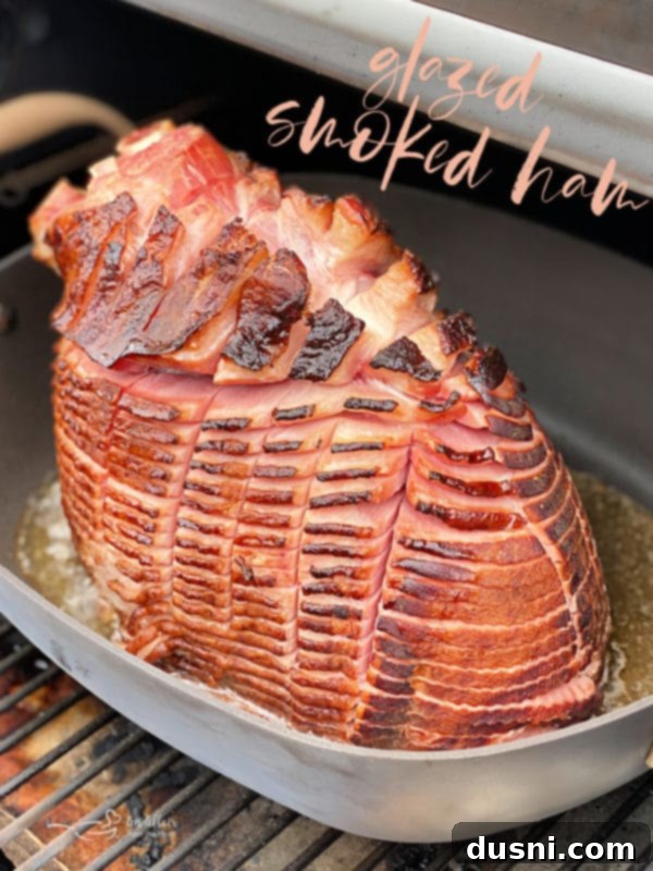 A glorious Glazed Smoked Ham, carved and ready for serving on a wooden board