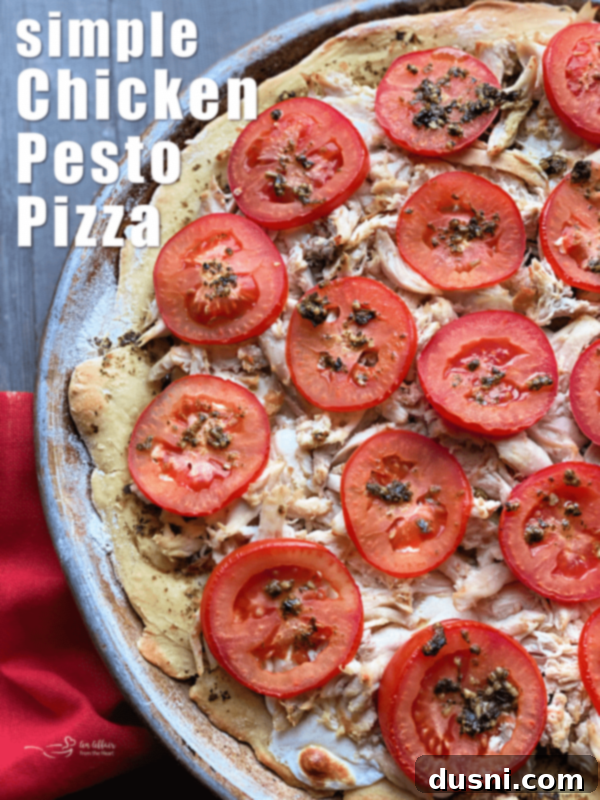 Hero shot of a perfectly baked Chicken Pesto Pizza, garnished with fresh basil.