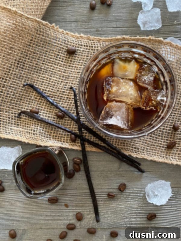 Two bottles of homemade Kahlua sitting on a wooden surface.