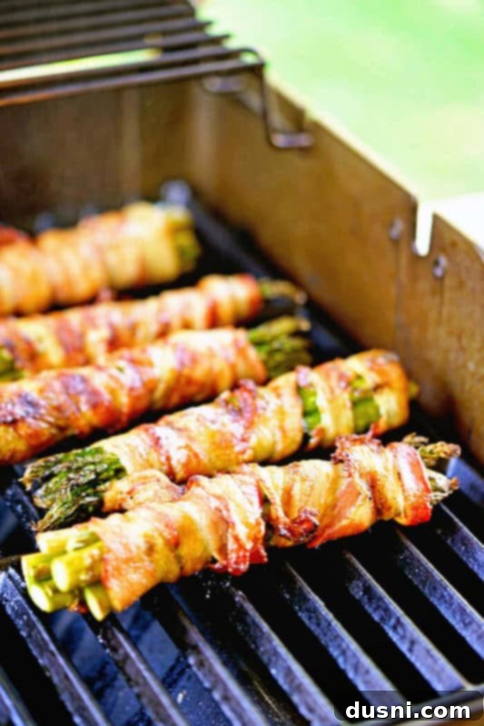 Bacon's Embrace: Recipes for Wrapped Perfection 13 Grilled bacon-wrapped asparagus bundles, a simple yet elegant side dish.