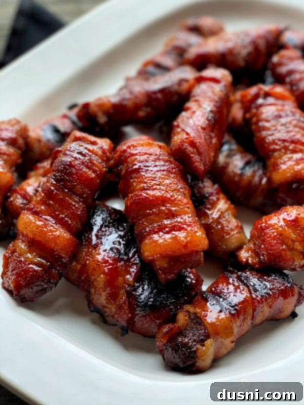 Bacon's Embrace: Recipes for Wrapped Perfection 9 Sweet & Spicy Bacon Wrapped Pork Ribs - tender pork ribs wrapped in bacon with a flavorful glaze.