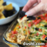 Dorothy's Hot Taco Dip with blue corn chip dipping