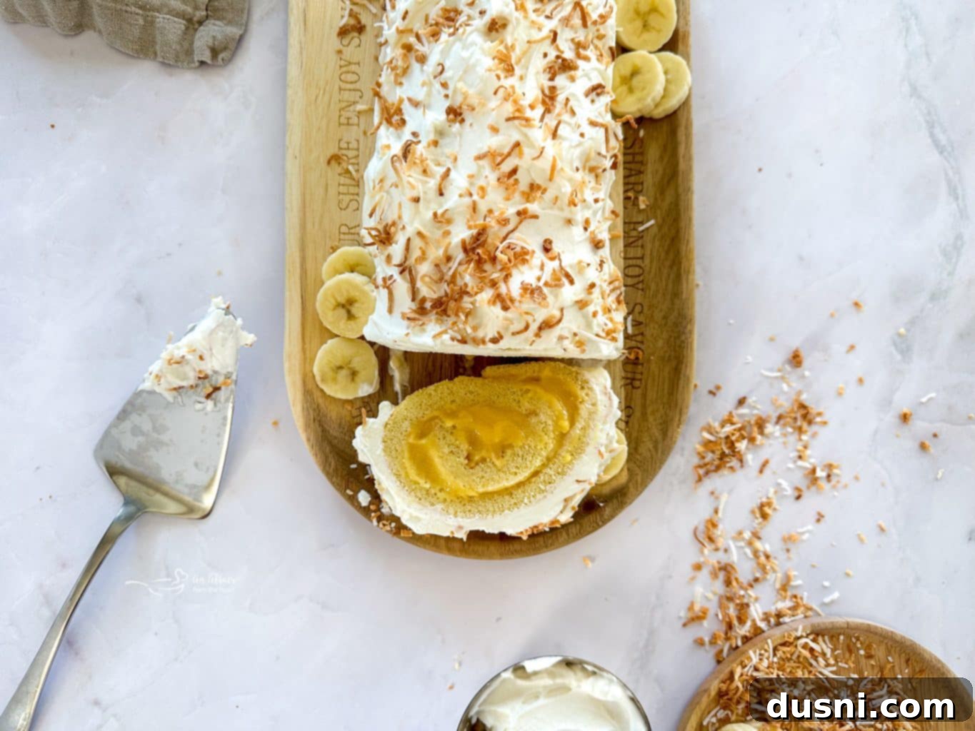 Banana Cream Roulade 5 A whole Banana Cream Jelly Roll Cake on a white platter