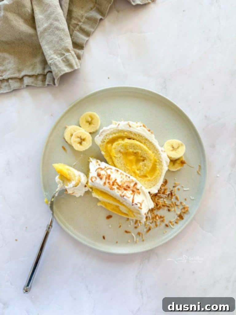 Banana Cream Roulade 6 A close-up of a slice of Banana Cream Jelly Roll Cake