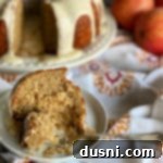 A beautifully sliced Caramel Apple Tea Cake with a bite taken from a piece on a fork, highlighting its moist texture and delicious glazes.