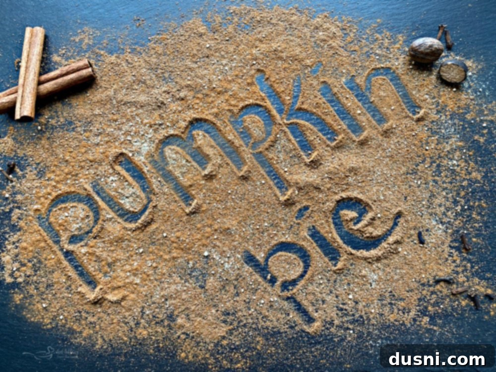 A jar of homemade pumpkin pie spice with whole spices around it.