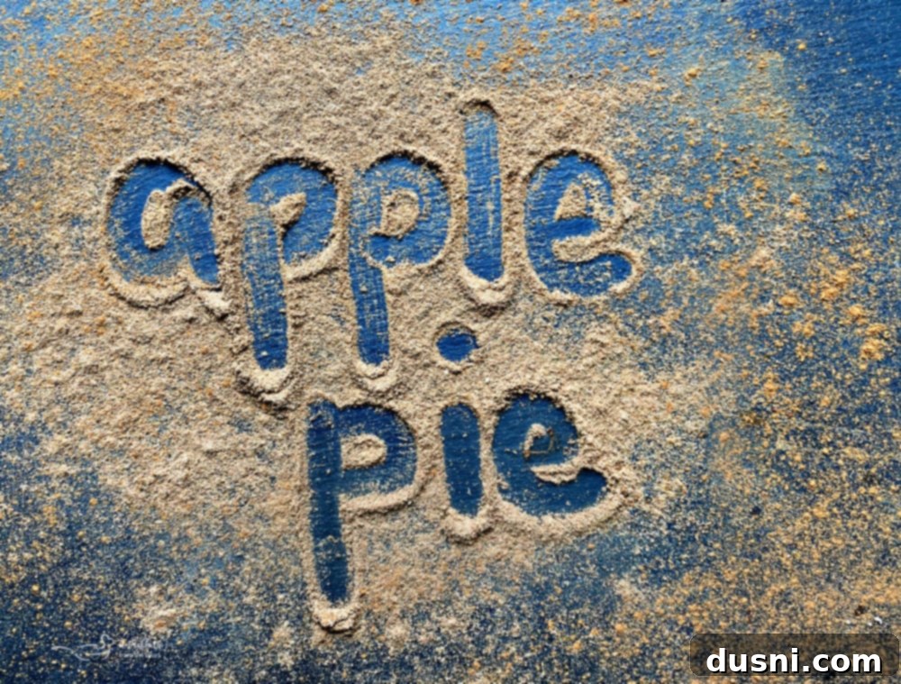 Apple Pie Spice in a jar with apples