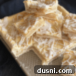 Effortless Apple Crumble Bars 11 Homemade Apple Bars cooling on a cookie sheet after baking, showing the golden-brown crust and glistening glaze.