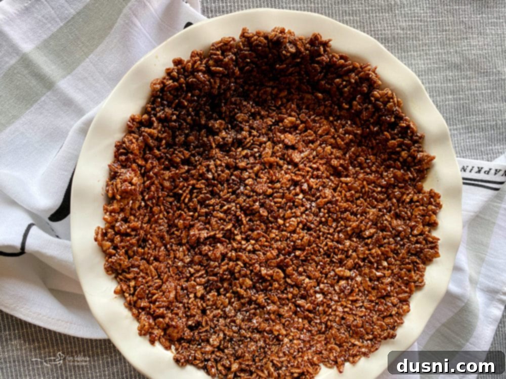 Chocolate Marshmallow Pie Crust with a scoop taken out