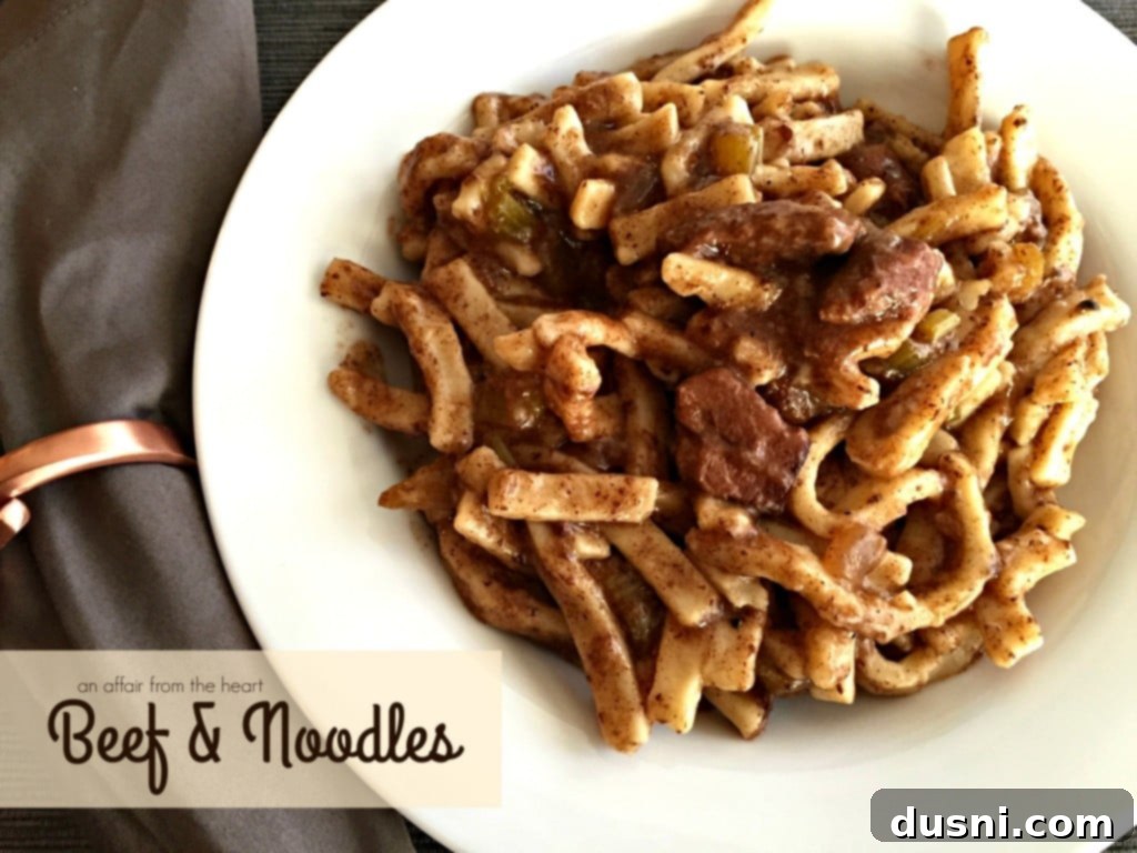 A large pot of simmering Beef & Noodles, showcasing the rich color of the gravy and the comforting appeal of the dish, ready for serving.