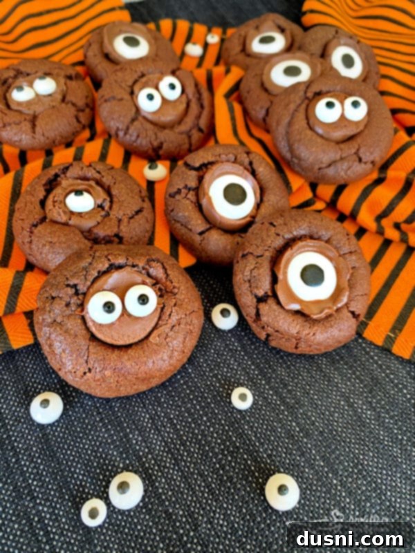 Sweet Gaze Chocolate Sugar Cookies 3 Chocolate sugar cookies with candy eyeballs on an orange and black towel.