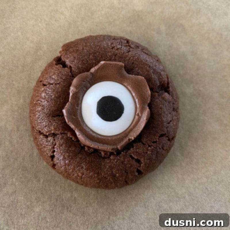 Sweet Gaze Chocolate Sugar Cookies 7 A tray of chocolate sugar cookies with melted Hershey's Kisses and candy eyeballs.