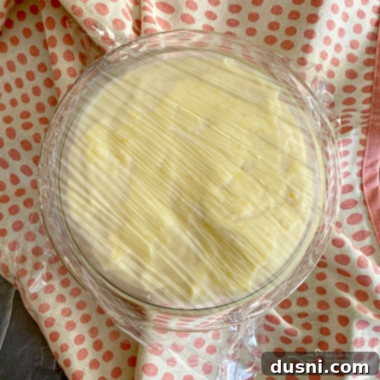 Custard covered with plastic wrap, ready for refrigeration