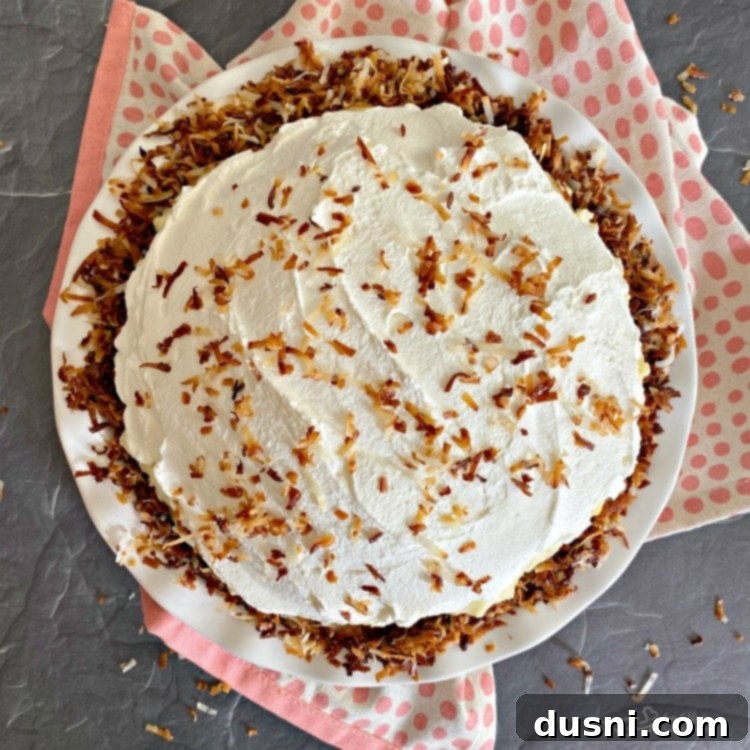 Topping a cream pie with whipped cream and toasted coconut