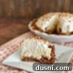 sliced Coconut Banana Cream Pie on a white plate, ready to be enjoyed