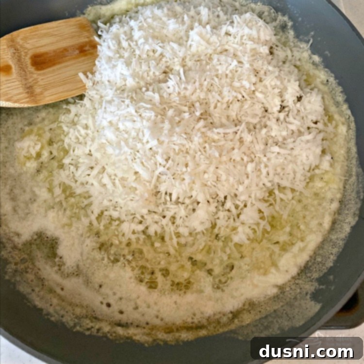 Melted butter and shredded coconut in a skillet