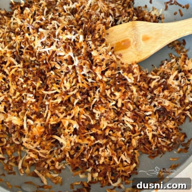Toasting coconut flakes in a pan for pie crust