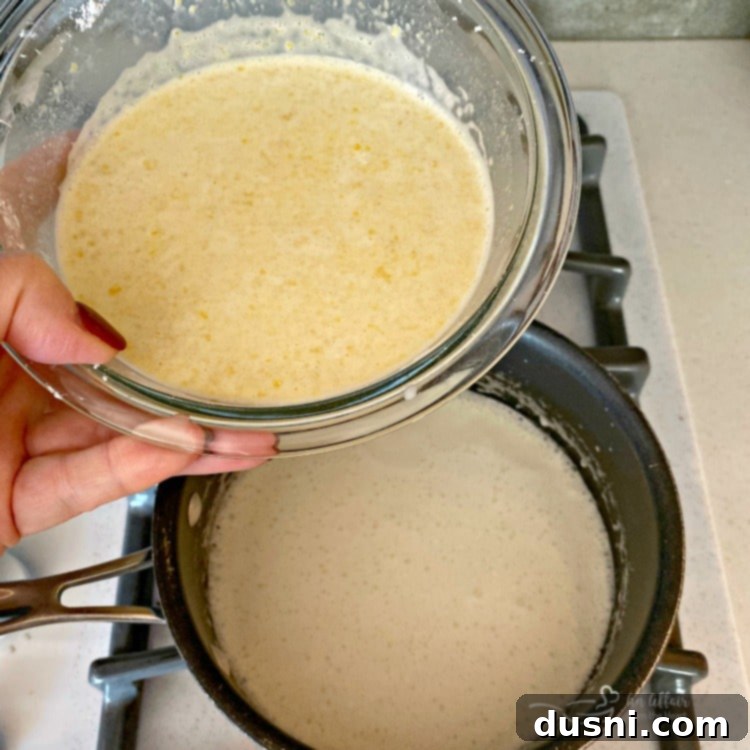 Adding egg mixture to hot sugar and half and half on the stove