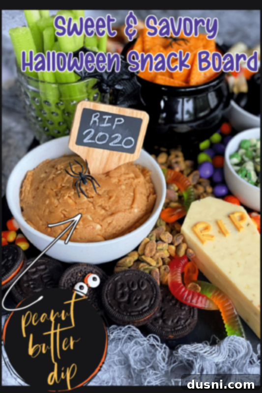 A Hauntingly Delicious Halloween Spread Sweet Savory and Peanut Butter Dip 8 A beautifully arranged Halloween snack board from a slightly elevated angle, showcasing the variety and festive decorations.
