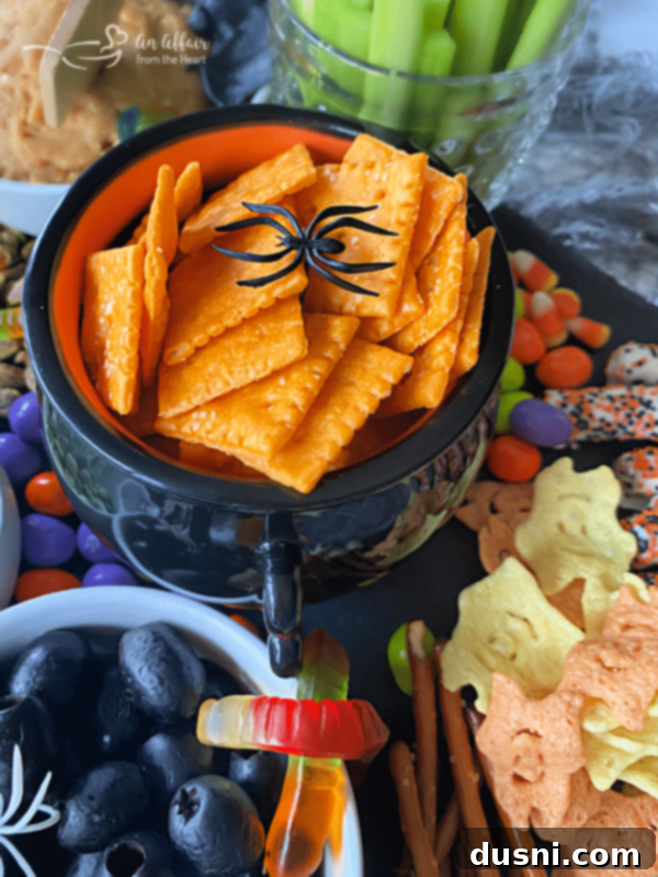 A Hauntingly Delicious Halloween Spread Sweet Savory and Peanut Butter Dip 9 A different angle of the Halloween snack board, highlighting the diverse textures and colors of the snacks and decorations.