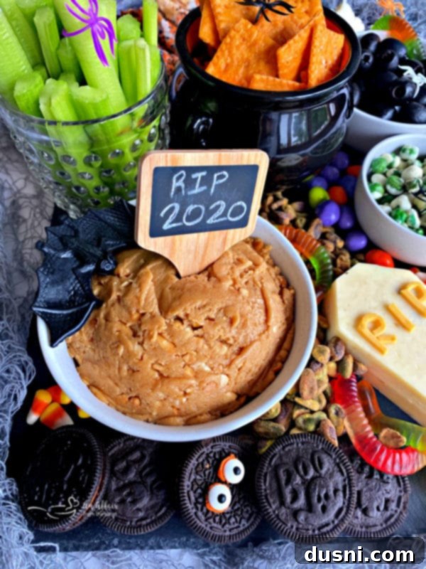 A Hauntingly Delicious Halloween Spread Sweet Savory and Peanut Butter Dip 10 A Halloween snack board styled differently, perhaps with more focus on the spread of items.