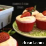Creamy Strawberry Bliss Cupcakes 2 Freshly baked Strawberries & Cream Cupcakes with creamy frosting and strawberry halves