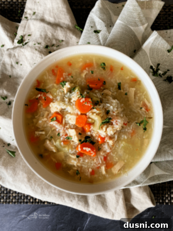 Close-up of a bowl of Instant Pot Chicken and Rice Soup with a spoon