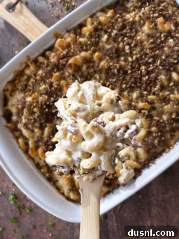 Close-up of a serving of Reuben Mac 'n Cheese, showing the rich texture and topping.