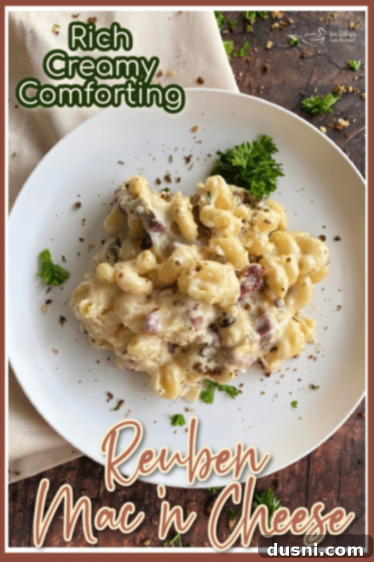 Reuben Mac 'n Cheese in a bowl on a wooden table, garnished with fresh parsley.