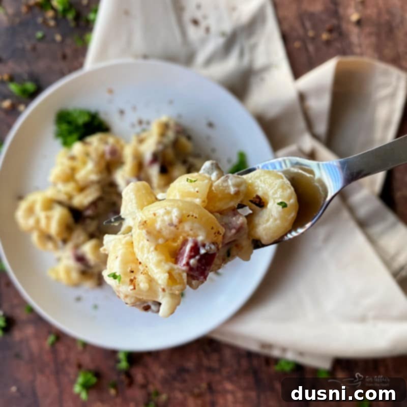 A large serving of Reuben Mac 'n Cheese in a baking dish, ready to be dished out.