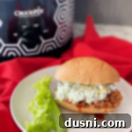 Spicy Slow Cooker Buffalo Pulled Pork with Cooling Celery Slaw 21 slow cooker buffalo pulled pork sandwich on white plate