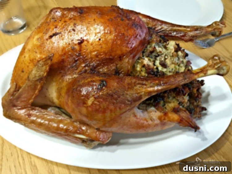 Mom's Pork Sausage and Sage Dressing 11 A beautifully roasted turkey served alongside a generous portion of Sausage and Sage Stuffing, a perfect Thanksgiving centerpiece.