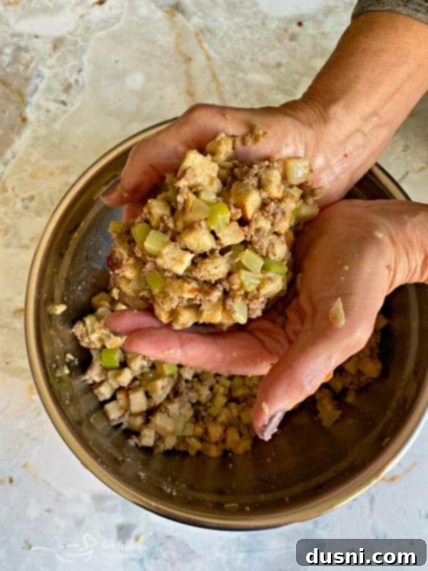Mom's Pork Sausage and Sage Dressing 8 The author's mom demonstrating how the sausage and sage dressing should stick together and form a ball when it has enough moisture.
