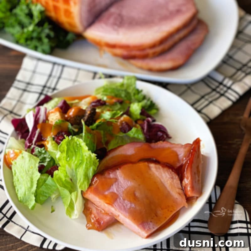 Perfectly Glazed Slow Cooker Ham 11 Serving suggestion for Dorothy's Slow Cooker Glazed Ham, beautifully plated and ready for a meal.