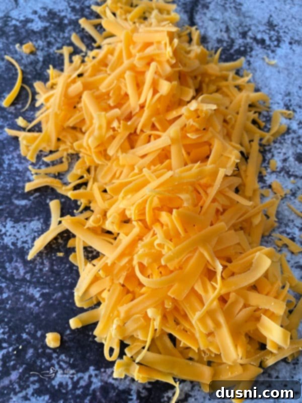 Why Freshly Grated Cheese Beats the Bag Every Time 3 Woman grating cheese