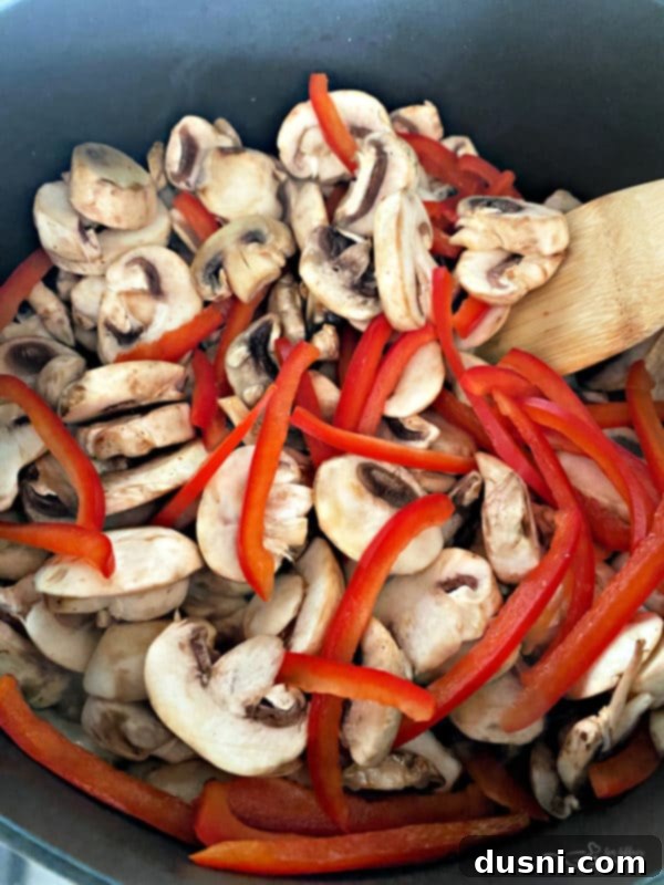 Ingredients laid out for Sophisticated Green Bean Casserole, including fresh green beans, pancetta, mushrooms, and herbs