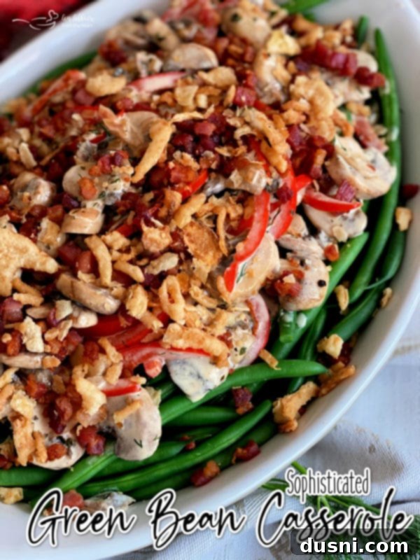 Sophisticated Green Bean Casserole hero shot, garnished with crispy pancetta and onions