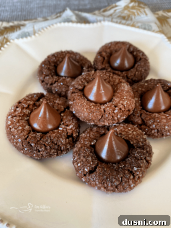 Sugar-Kissed Chocolate Delights 3 Pile of freshly baked Chocolate Sugar Kiss Cookies with a gold background
