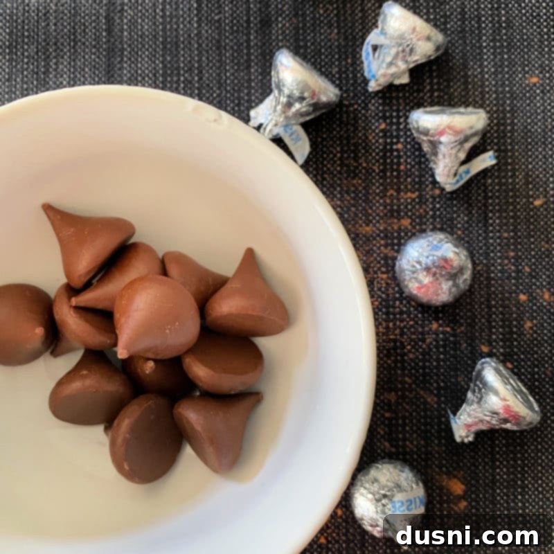 Sugar-Kissed Chocolate Delights 5 Preparing Halloween Chocolate Sugar cookies with chocolate kisses on a tray