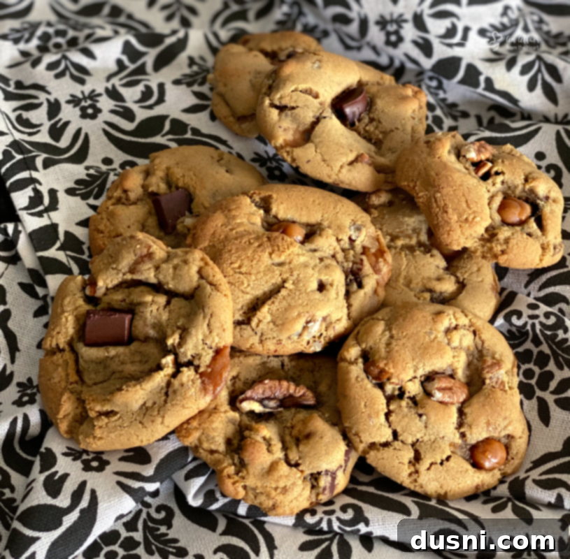 Gooey Turtle Delights 3 Plate of baked turtle cookies, some with visible melted caramel and chocolate.