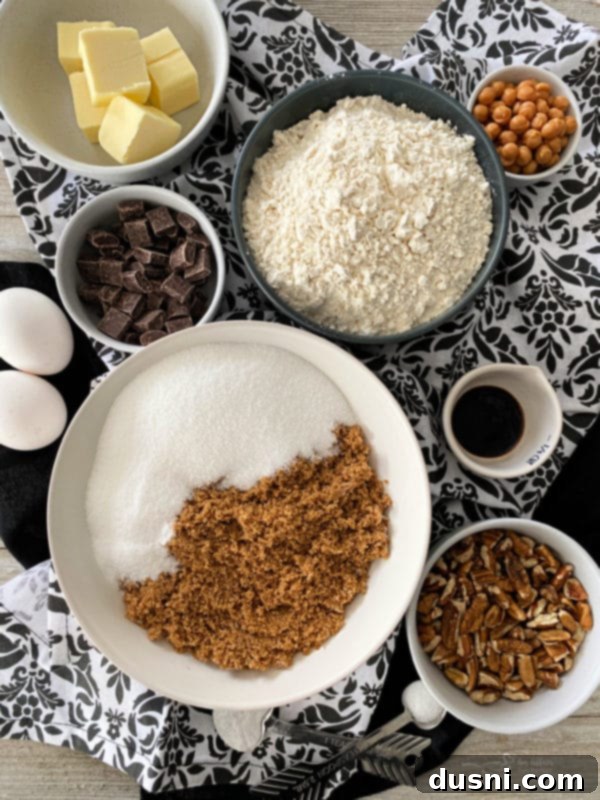 Gooey Turtle Delights 4 A stack of three turtle cookies on a white plate, with a coffee mug in the background, showcasing the rich textures.