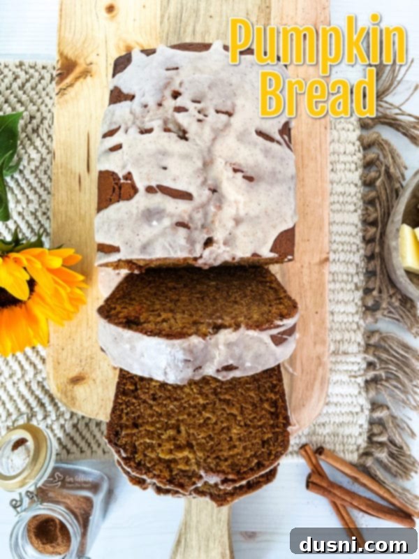 Two loaves of homemade pumpkin bread cooling on a wire rack