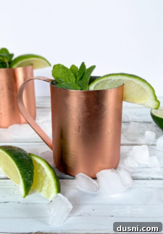 The Ginger Kick from Moscow 2 Close up of a frosty copper mug filled with a Moscow Mule, garnished with a lime wedge.