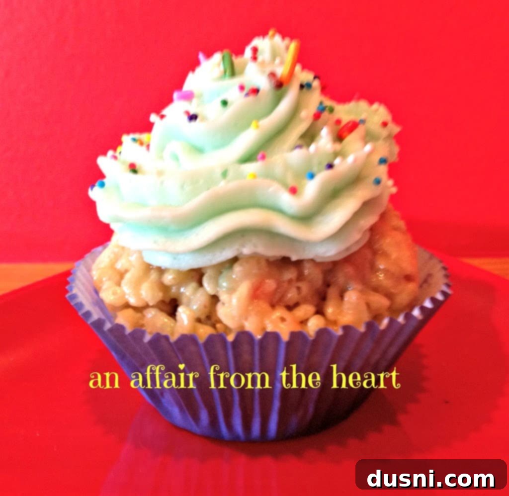A close-up of a single Cake Batter Rice Krispie Cupcake showing its texture and frosting