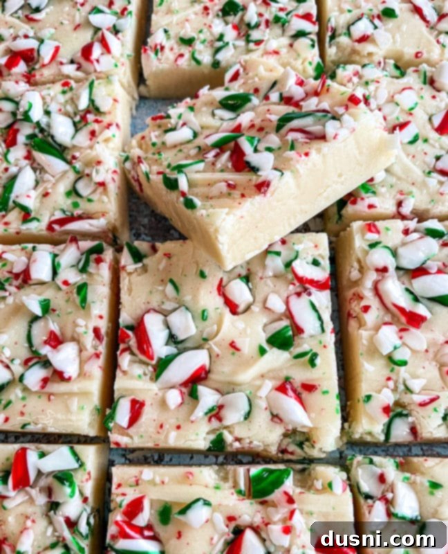 Close-up of a stack of white chocolate peppermint fudge squares.
